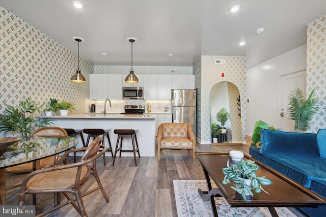 living room featuring sink and light wood-type flooring