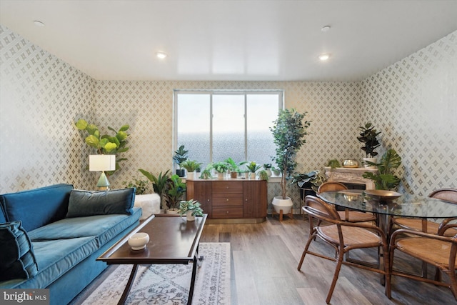 living room featuring light hardwood / wood-style floors and a water view