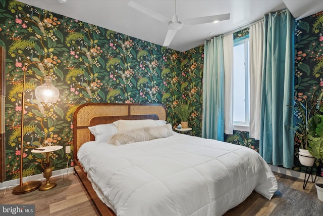 bedroom with hardwood / wood-style flooring and ceiling fan