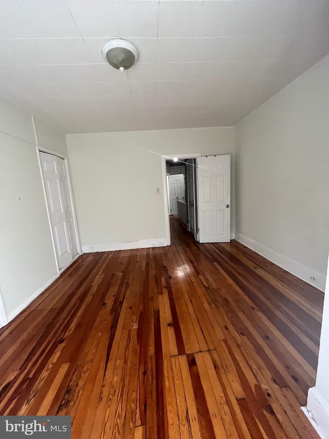 empty room featuring dark wood-type flooring