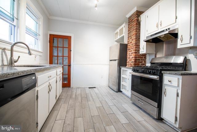 kitchen featuring stainless steel appliances, white cabinetry, and sink