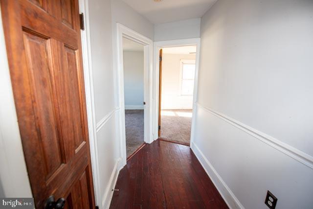 hall featuring dark wood-type flooring