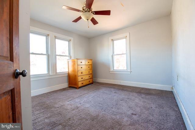 unfurnished bedroom with light carpet and ceiling fan