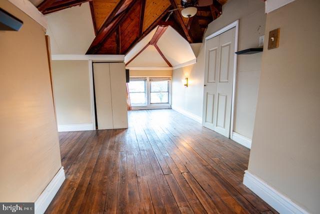 interior space with lofted ceiling, ceiling fan, and dark hardwood / wood-style floors