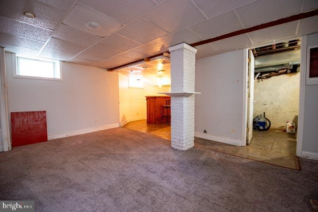 basement featuring carpet and bar