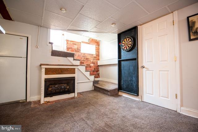 unfurnished living room with a fireplace and carpet floors