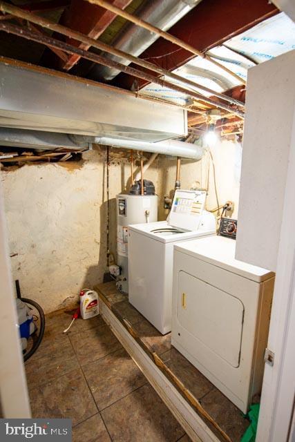 clothes washing area with water heater and washing machine and clothes dryer