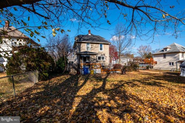 rear view of property with a yard