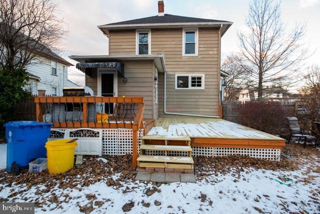 snow covered property featuring a wooden deck