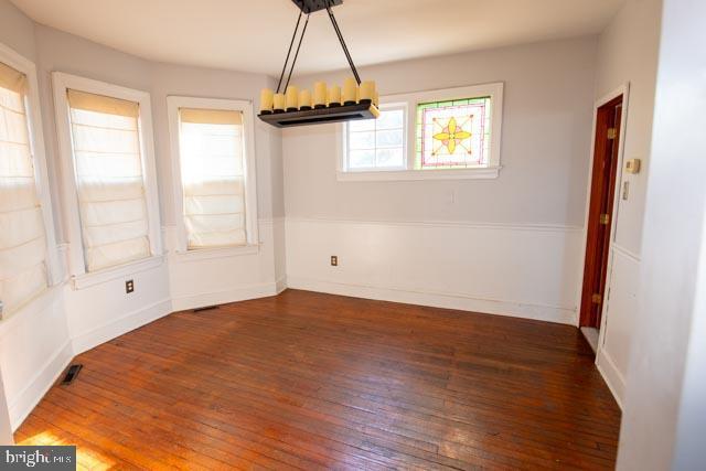 unfurnished dining area featuring dark hardwood / wood-style floors