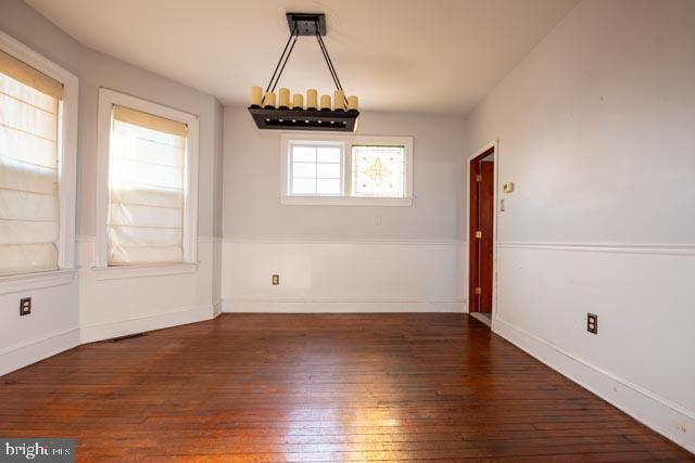 unfurnished dining area with dark hardwood / wood-style flooring