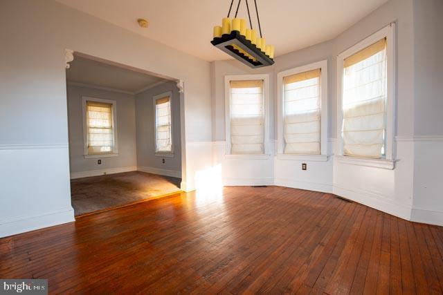 unfurnished dining area featuring dark hardwood / wood-style floors