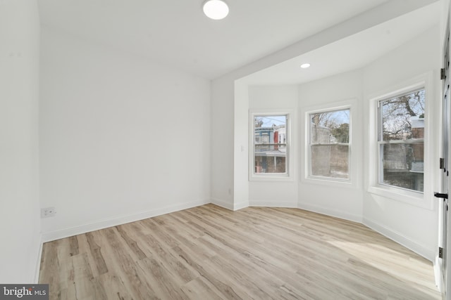 spare room featuring light wood-type flooring