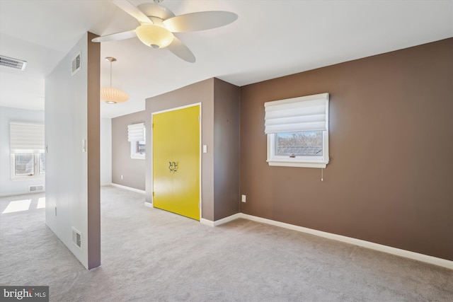 carpeted empty room featuring ceiling fan