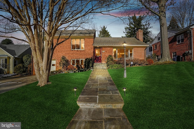 split level home featuring a yard