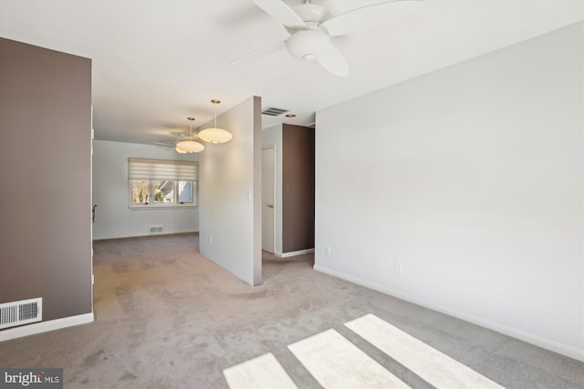 spare room featuring ceiling fan and light carpet