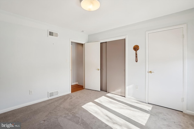 unfurnished bedroom featuring light carpet