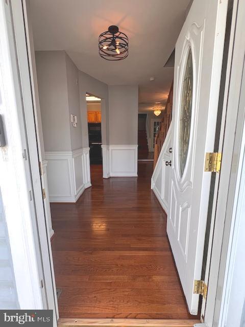 corridor featuring dark wood-type flooring