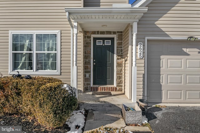 doorway to property featuring a garage