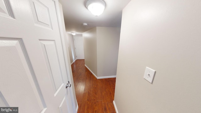 hallway with hardwood / wood-style floors