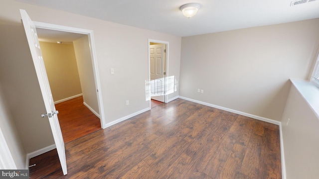 unfurnished bedroom featuring dark hardwood / wood-style floors