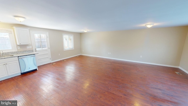 interior space with white cabinets, dark wood-type flooring, dishwasher, and sink