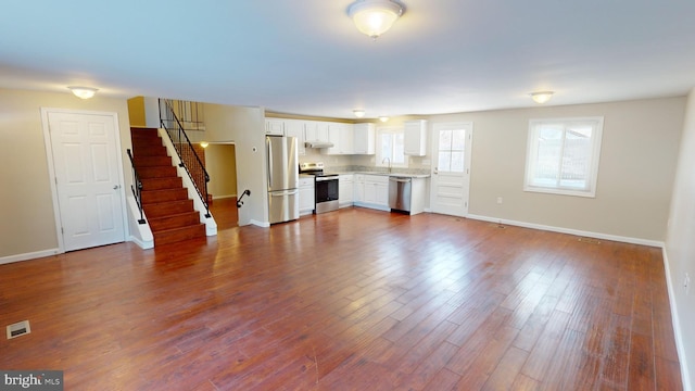 unfurnished living room featuring hardwood / wood-style flooring