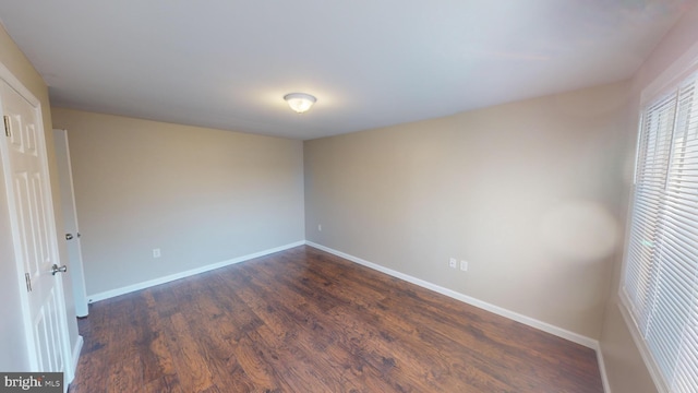 spare room featuring dark hardwood / wood-style flooring