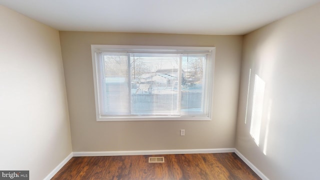 unfurnished room with dark hardwood / wood-style floors