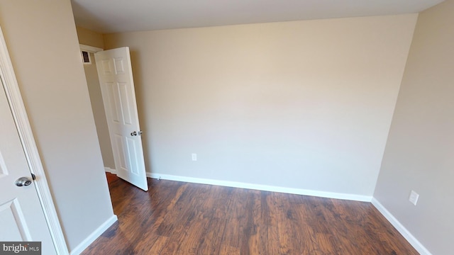 unfurnished room featuring dark hardwood / wood-style floors