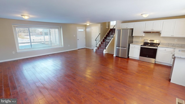 kitchen featuring dark hardwood / wood-style flooring, white cabinets, and appliances with stainless steel finishes