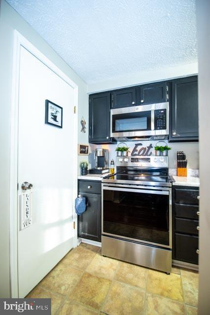 kitchen featuring stainless steel appliances and a textured ceiling