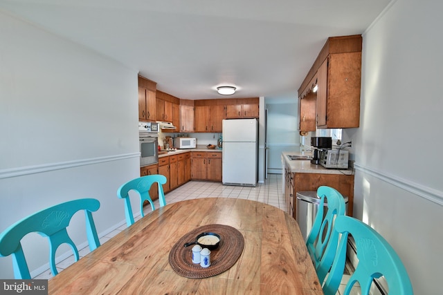 tiled dining room with sink