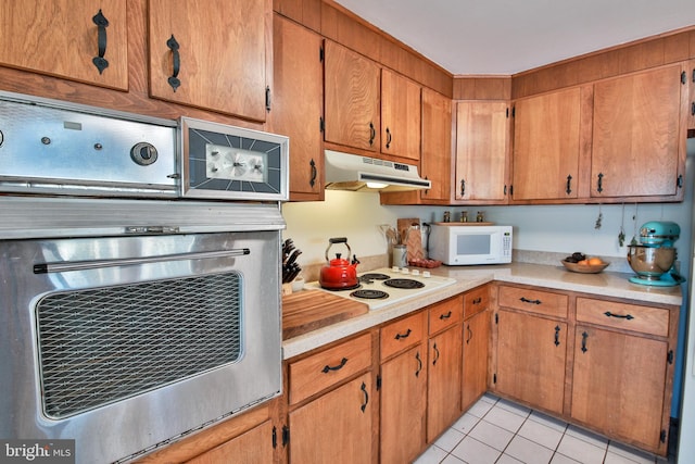 kitchen featuring white appliances and light tile patterned floors