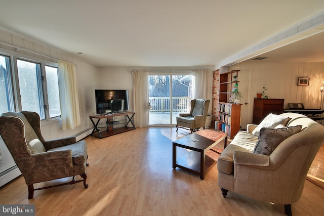 living room with light hardwood / wood-style flooring and a baseboard radiator