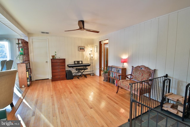 living area with ceiling fan and light wood-type flooring