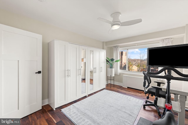 office with dark hardwood / wood-style floors and ceiling fan