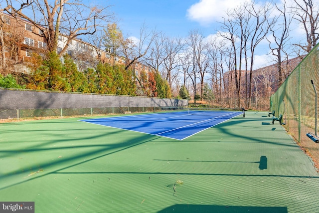 view of tennis court with a mountain view