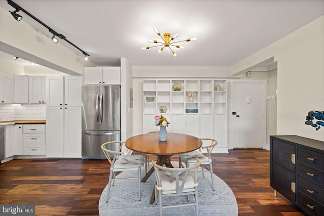 dining area featuring dark hardwood / wood-style flooring and an inviting chandelier