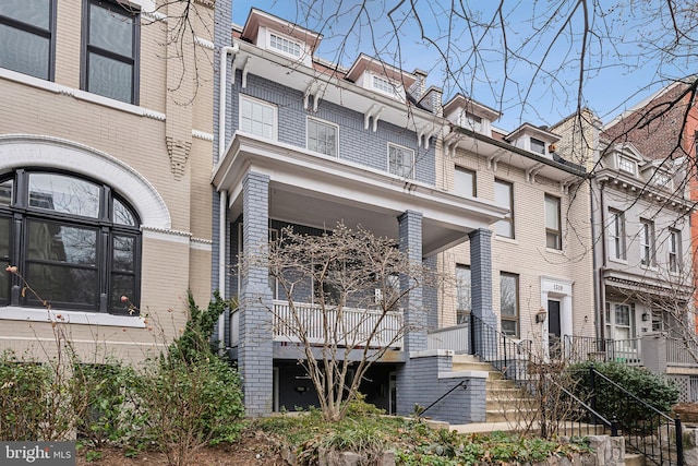 view of front of house featuring mansard roof