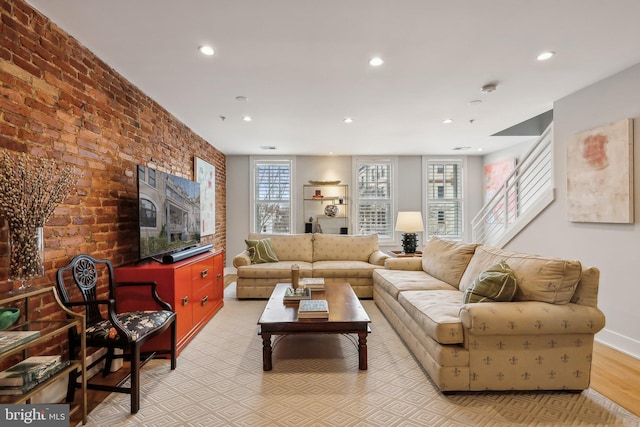 living room with brick wall, recessed lighting, and a healthy amount of sunlight