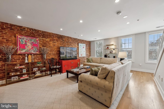 living room featuring recessed lighting, brick wall, visible vents, light wood-style floors, and baseboards