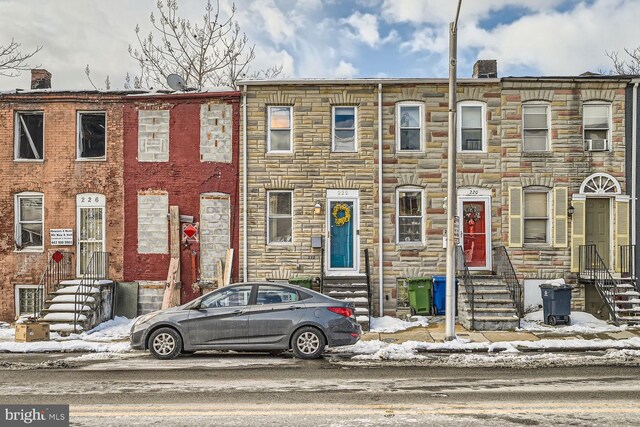 222 S Carey St, Baltimore, MD 21223 - townhome / multi-family property with entry steps, stone siding, and cooling unit