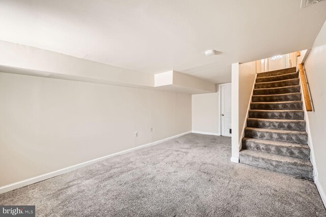 222 S Carey St, Baltimore, MD 21223 - finished basement with carpet flooring, stairway, and baseboards