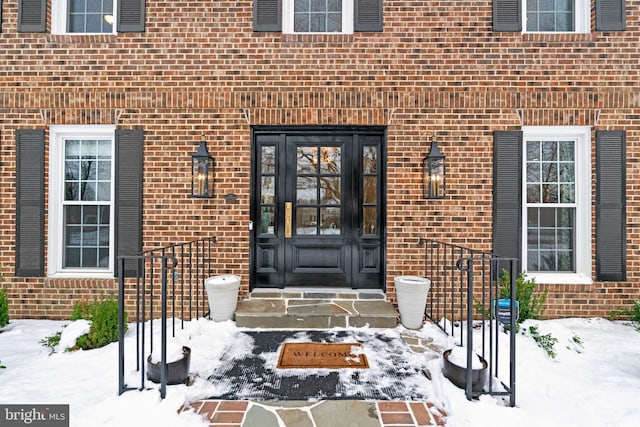 view of snow covered property entrance