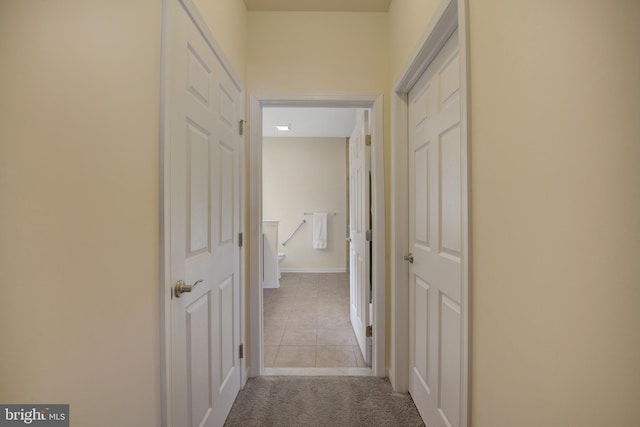 corridor with light colored carpet