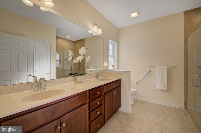 bathroom with tile patterned flooring, vanity, an enclosed shower, and toilet