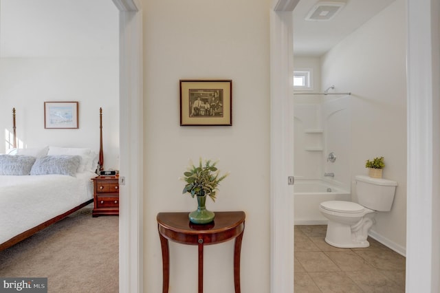 interior space featuring shower / bathing tub combination, tile patterned flooring, and toilet