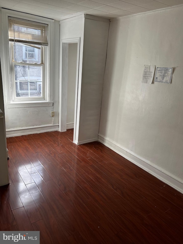 spare room with dark wood-type flooring