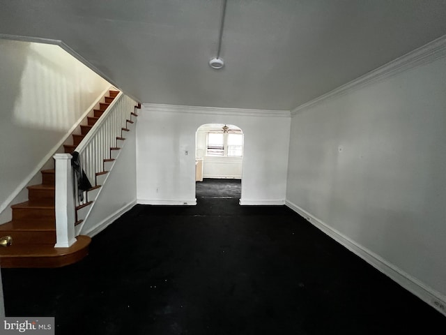 interior space with ceiling fan and crown molding